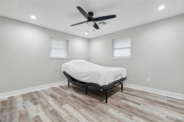 bedroom featuring light wood-type flooring, visible vents, baseboards, and recessed lighting