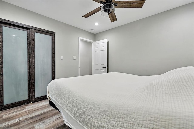 bedroom featuring recessed lighting, ceiling fan, and wood finished floors