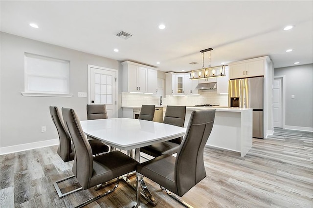 dining area with baseboards, recessed lighting, visible vents, and light wood-type flooring