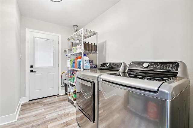 laundry area featuring laundry area, light wood-style flooring, baseboards, and independent washer and dryer