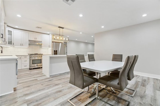 dining room with recessed lighting, visible vents, baseboards, and light wood-style flooring