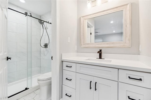 full bathroom featuring vanity, recessed lighting, a shower stall, tile patterned floors, and toilet