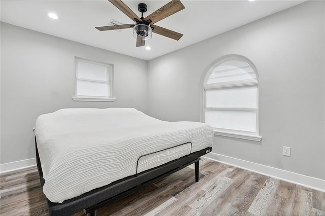 bedroom featuring recessed lighting, wood finished floors, and baseboards