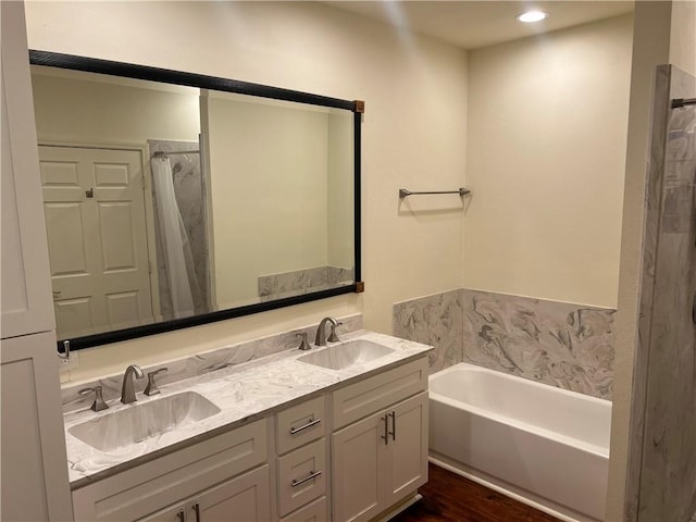 bathroom with double vanity, a shower with shower curtain, a sink, and a bath