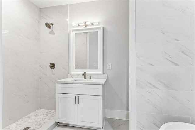 bathroom with vanity and a tile shower