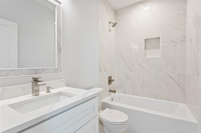 full bathroom featuring vanity, toilet, and tiled shower / bath combo