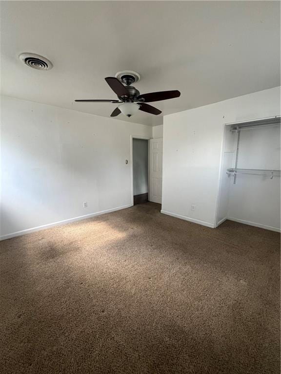 unfurnished bedroom with carpet floors, ceiling fan, and a closet