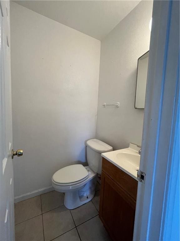 bathroom with vanity, tile patterned floors, and toilet