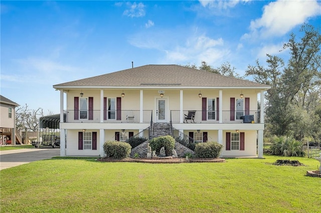 view of front of property featuring a front yard, a carport, and covered porch