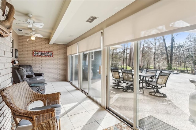 sunroom / solarium featuring beam ceiling