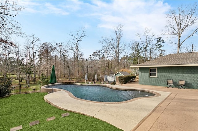 view of swimming pool featuring a patio area and a lawn