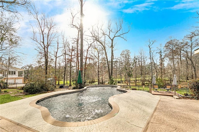 view of swimming pool featuring a wooden deck and a patio