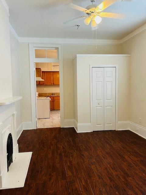 unfurnished living room featuring hardwood / wood-style floors, crown molding, and ceiling fan