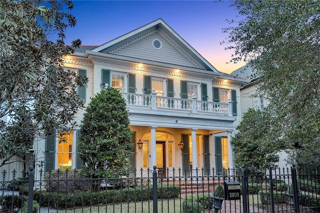 2809 Prytania St, New Orleans, LA 70115 - neoclassical / greek revival house with covered porch, a balcony, a fenced front yard, and brick siding