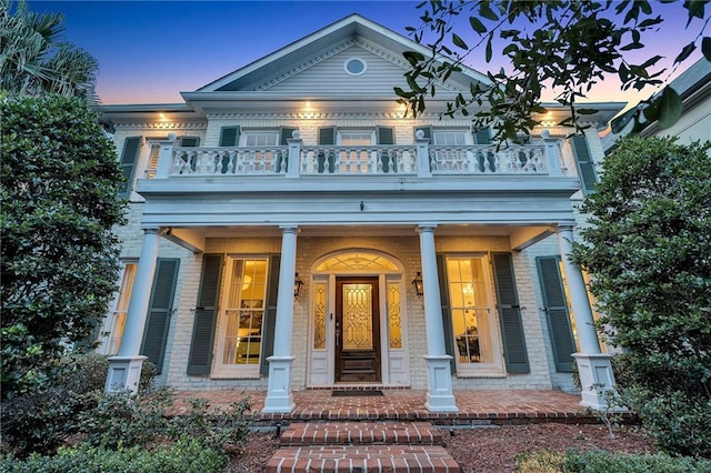 view of front facade with a balcony and a porch