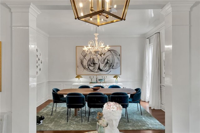 2809 Prytania St, New Orleans, LA 70115 - dining space with a chandelier, dark wood-style flooring, crown molding, wainscoting, and a decorative wall