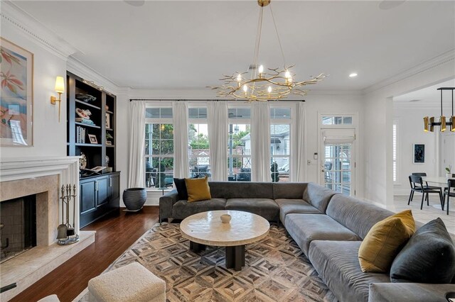 2809 Prytania St, New Orleans, LA 70115 - living area with a chandelier, ornamental molding, a fireplace, recessed lighting, and wood finished floors