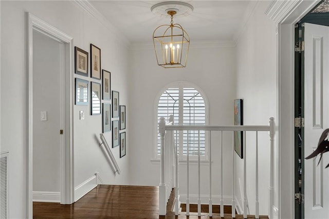 2809 Prytania St, New Orleans, LA 70115 - entryway with a chandelier, ornamental molding, baseboards, and wood finished floors