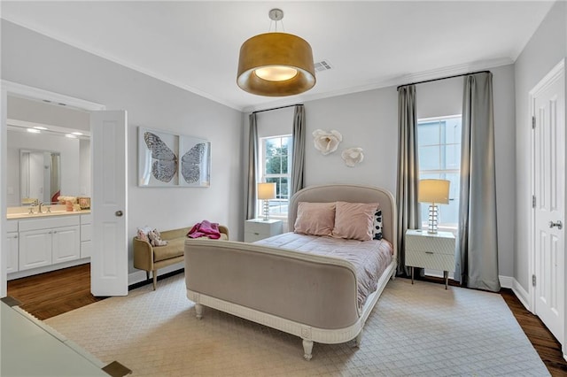2809 Prytania St, New Orleans, LA 70115 - bedroom featuring dark wood-style flooring, multiple windows, ornamental molding, a sink, and ensuite bathroom