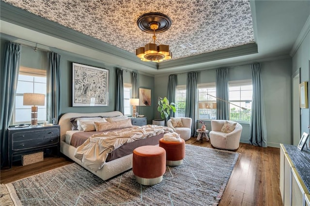 2809 Prytania St, New Orleans, LA 70115 - bedroom featuring a tray ceiling, ornamental molding, wood-type flooring, and baseboards