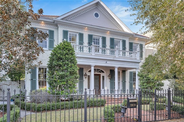 2809 Prytania St, New Orleans, LA 70115 - greek revival inspired property with a porch, a balcony, and a fenced front yard