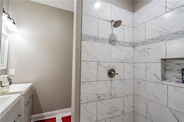 bathroom with vanity and a tile shower