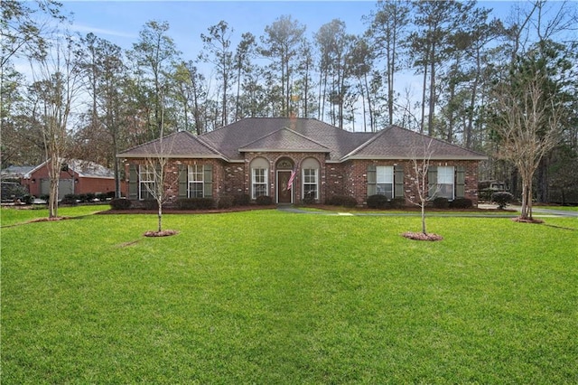 ranch-style home with a front lawn