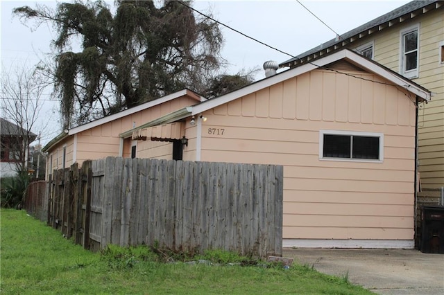 view of side of home featuring a yard