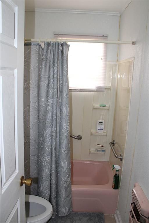 bathroom with toilet and shower / bath combo with shower curtain