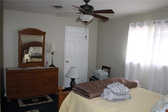 bedroom with multiple windows and ceiling fan