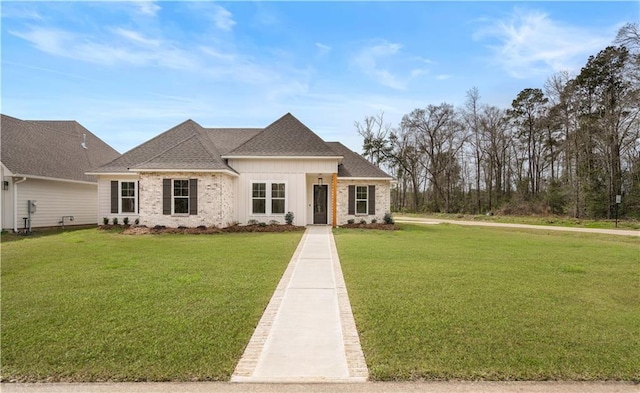 view of front of property with roof with shingles, board and batten siding, and a front yard