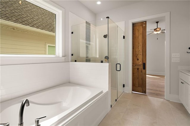 full bath featuring a garden tub, a ceiling fan, vanity, a shower stall, and tile patterned flooring