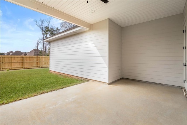 view of patio with a ceiling fan and fence