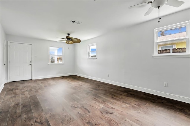 unfurnished room with ceiling fan and dark hardwood / wood-style flooring