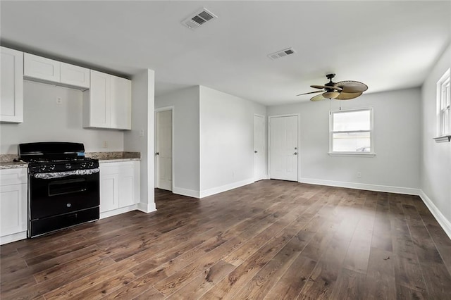 3005 Jasper St, Kenner, LA 70065 - kitchen with black gas range, light stone counters, white cabinetry, and dark hardwood / wood-style flooring