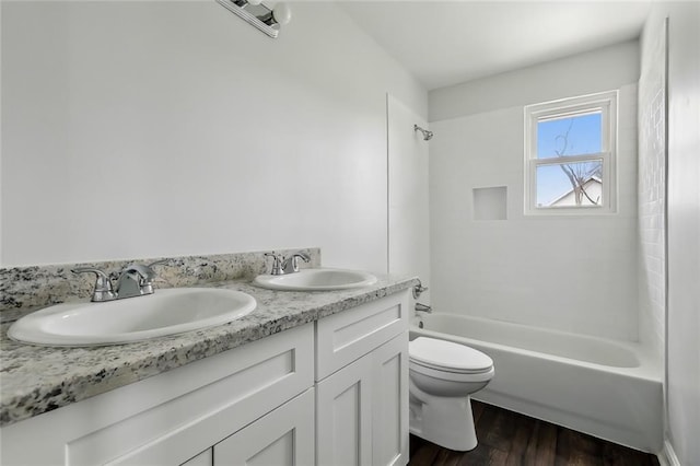 3005 Jasper St, Kenner, LA 70065 - full bathroom featuring tiled shower / bath combo, vanity, hardwood / wood-style floors, and toilet