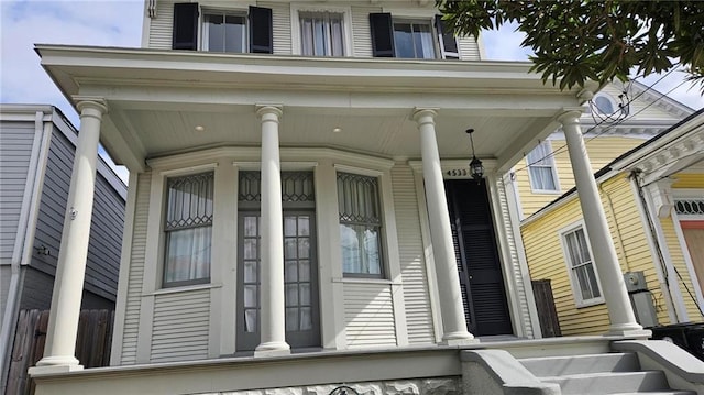 view of exterior entry with a porch