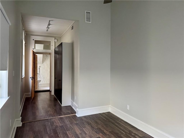 unfurnished room featuring dark wood finished floors, baseboards, and visible vents