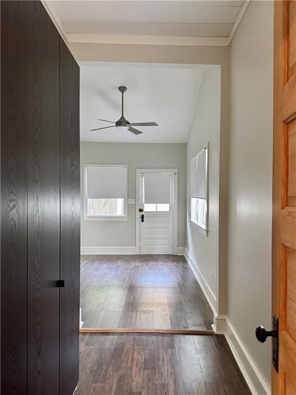 entryway with baseboards, wood-type flooring, and ceiling fan