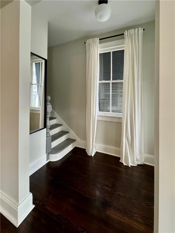 stairs featuring baseboards and wood finished floors