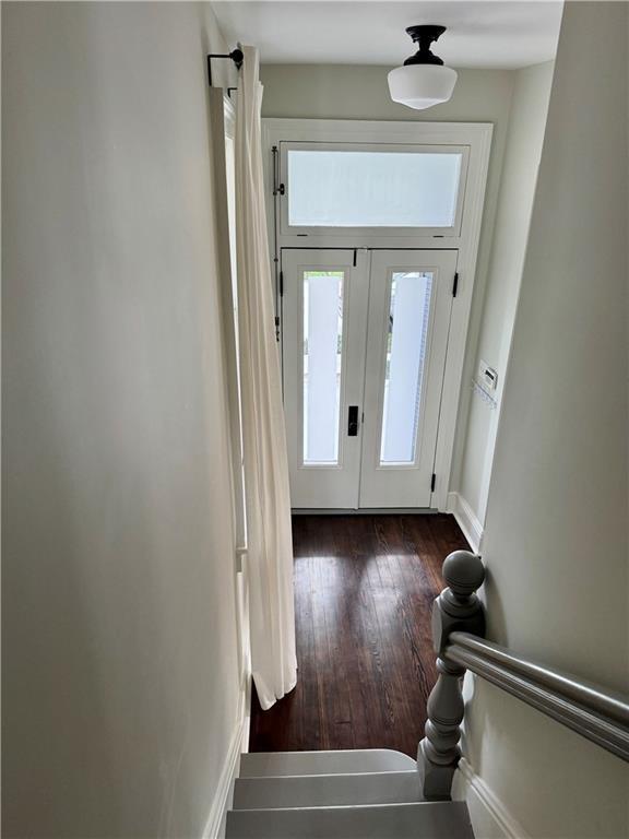 entrance foyer featuring french doors, baseboards, and dark wood-style flooring