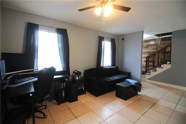 office featuring light tile patterned flooring, ceiling fan, and a healthy amount of sunlight