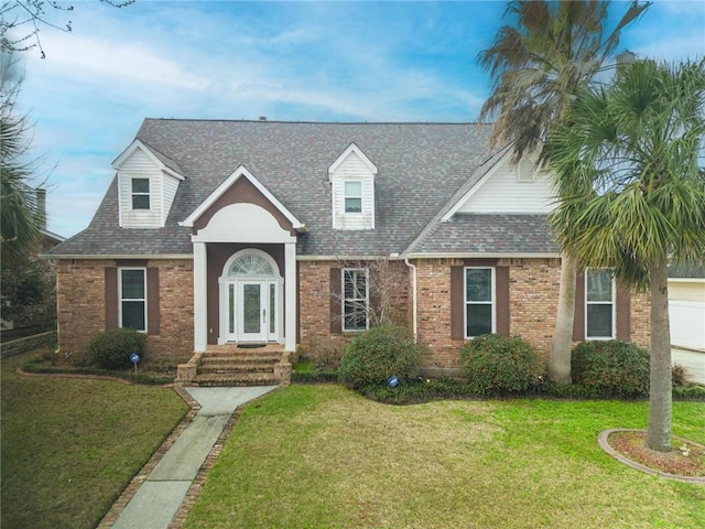 302 Charles Ct, Slidell, LA 70458 - cape cod home with brick siding, a front yard, and a shingled roof