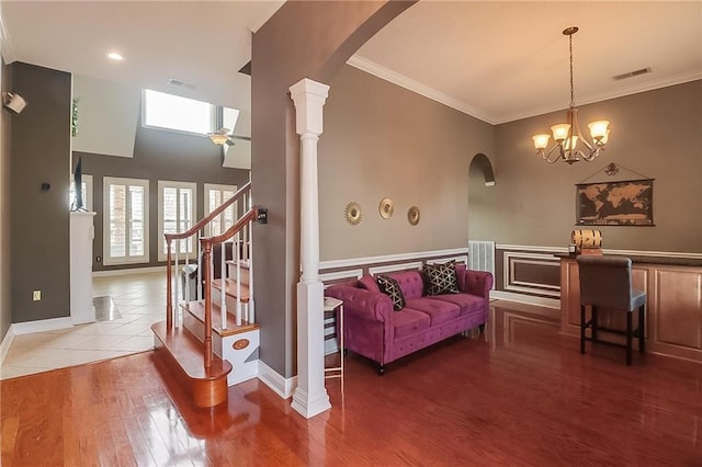 302 Charles Ct, Slidell, LA 70458 - living room with arched walkways, crown molding, ceiling fan, wood finished floors, and a chandelier