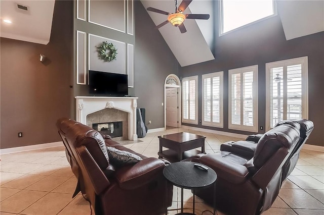 living room with light tile patterned floors, a wealth of natural light, and a high end fireplace