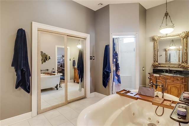 bathroom featuring tile patterned flooring, vanity, and a bathtub