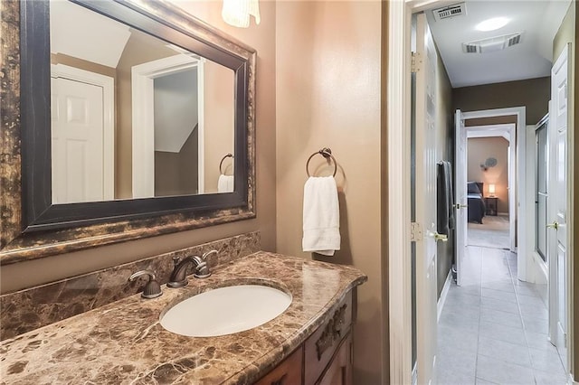 bathroom with tile patterned floors and vanity