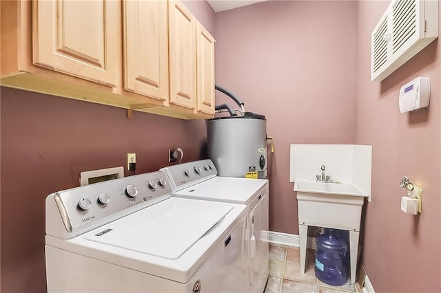 laundry room featuring cabinets, light tile patterned floors, washing machine and dryer, and water heater