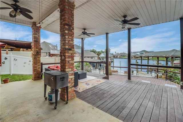 exterior space with an outdoor hangout area, ceiling fan, and a water view