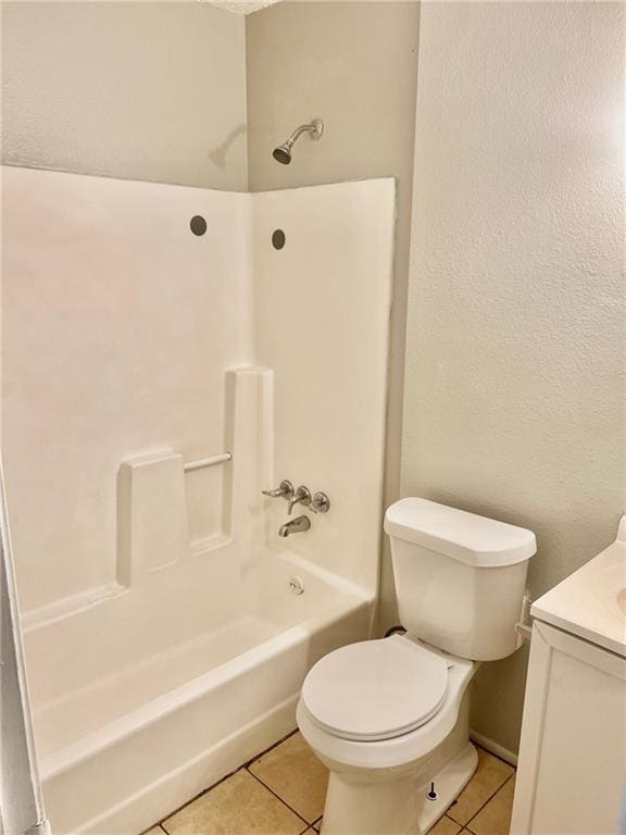 full bathroom with vanity, bathtub / shower combination, tile patterned floors, and toilet